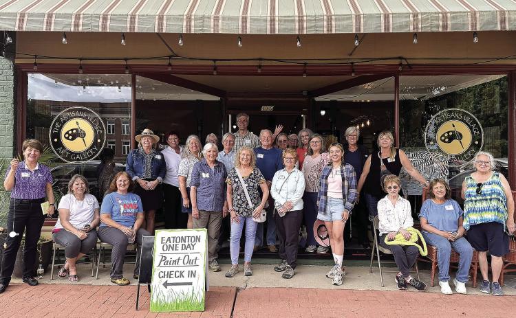 Attendees of the 8th annual Paint Out pose in front of the Artisan Village Guild. CONTRIBUTED